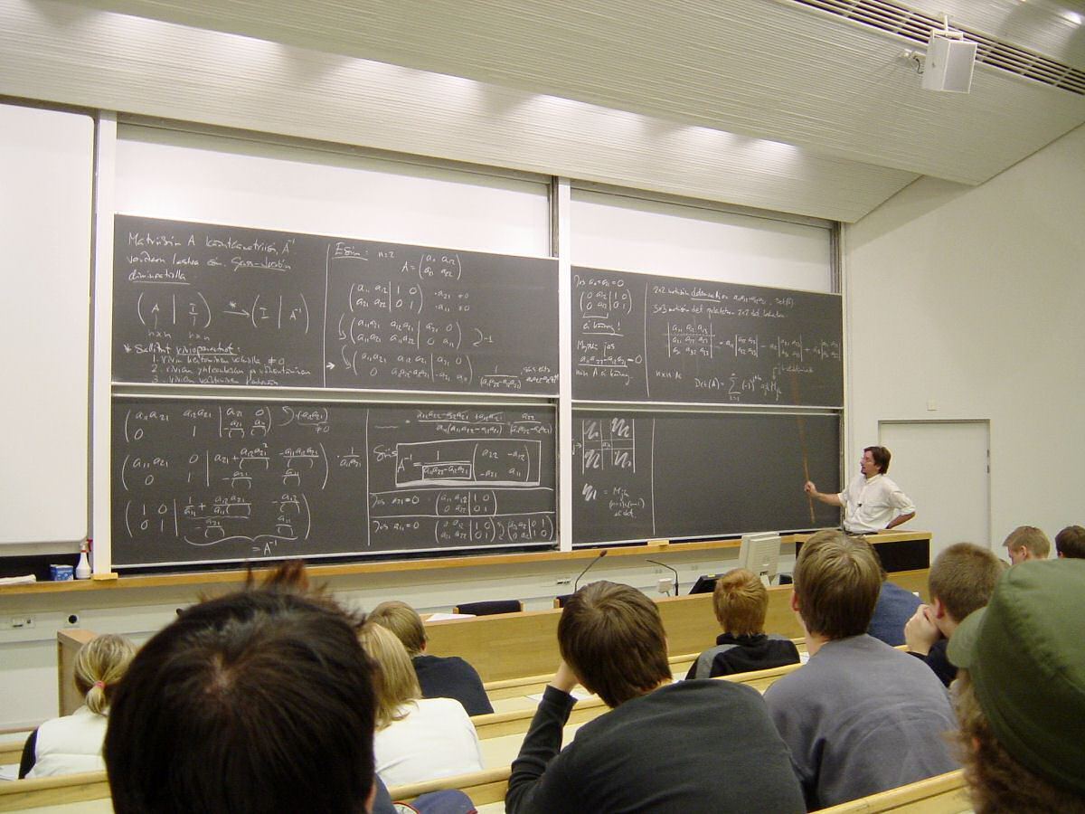 Mathematics lecture with formulas on a board explaining the z-score formula